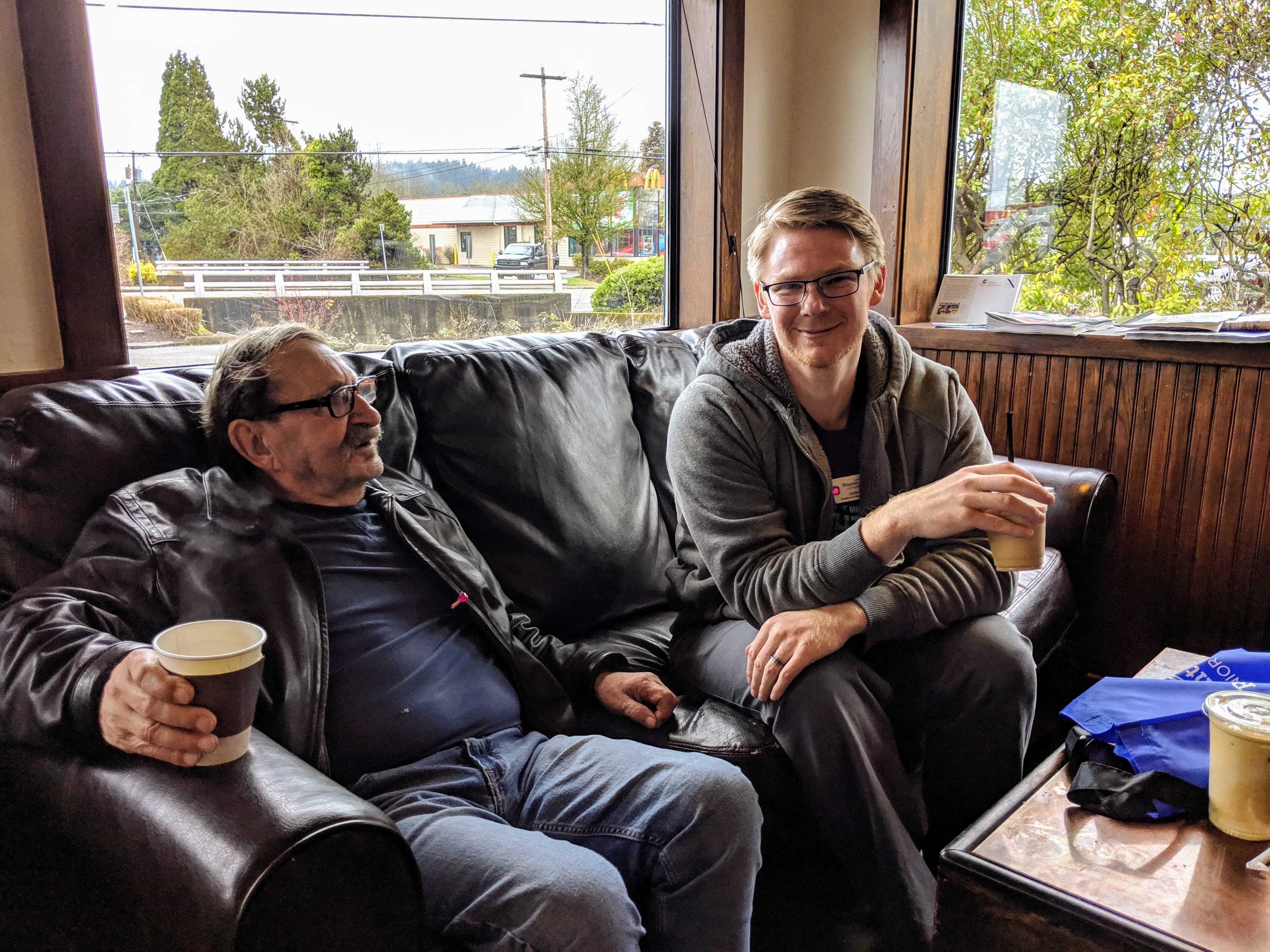 Greatness Digital's founder sharing coffee and conversation with a senior